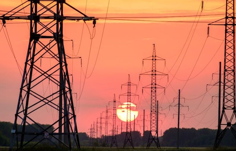 Power Lines - silhouette of electric post during sunset