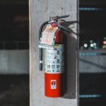 Fire Safety - red fire extinguisher mounted on wall
