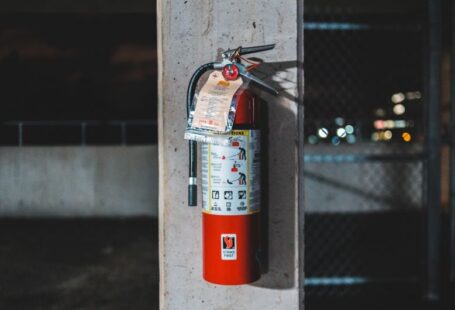 Fire Safety - red fire extinguisher mounted on wall