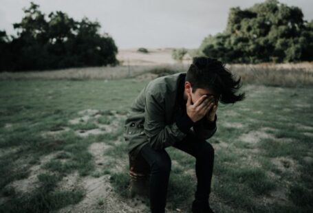 Tree Ailments - man wearing green jacket sitting on stool chair