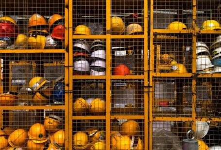 Safety Equipment - a rack filled with lots of yellow hard hats