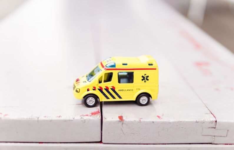 Emergency Removal - yellow car toy on white surface