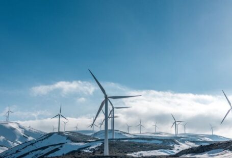 Environment Protection - wind turbines on snowy mountain under clear blue sky during daytime