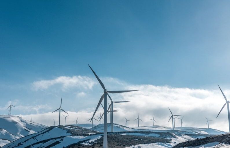 Environment Protection - wind turbines on snowy mountain under clear blue sky during daytime