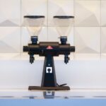 Stump Grinder - black and gray liquor dispenser near white wall