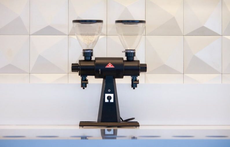 Stump Grinder - black and gray liquor dispenser near white wall