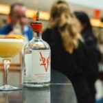 Summer Preparation - selective photography of clear glass bottle on table