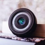 Mulching Technique - black Canon camera lens leaning on white book