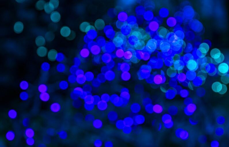 Holiday Lighting - a blurry photo of blue lights in the dark