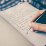 Emergency Plan - person writing bucket list on book